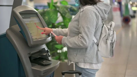 Woman using self check-in machine in the airport. woman checks Stock Footage 154652298
