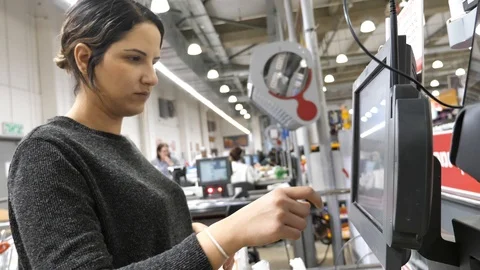 Woman using self checkout machine Stock Footage 86189980