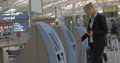 Woman using self-service machine to check-in Video stock 67296261