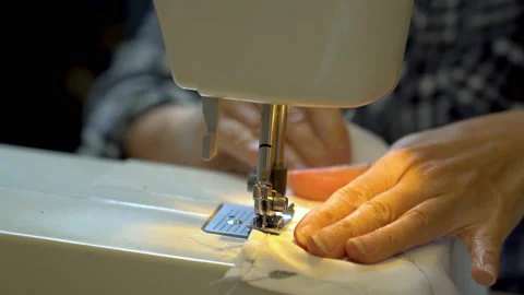 Woman using sewing machine Stock Footage 131413162