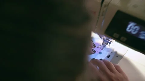 Woman using sewing machine Stock Footage 166171363