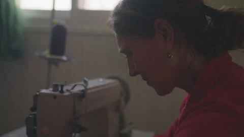Woman using a sewing machine Stock Footage 275076552