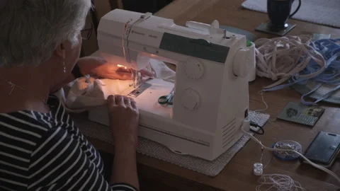 Woman using a sewing machine at home Stock Footage 130325577
