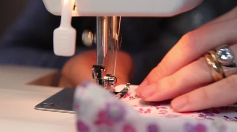 Woman using sewing machine to make dress Stock Footage 60428176