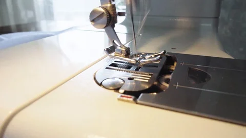Woman using sewing machine to pre-stitch the thread and needle to the seam Stock Footage 106757920