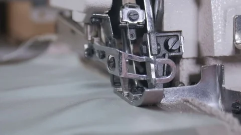 A woman using a sewing machine to sew fabric together Stock-Footage 81664476