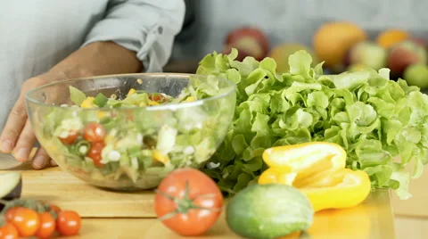 Woman using sharp knife while chopping garlic on the wooden board, dolly shot Stock Footage