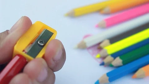 Woman is using sharpener, use for sharpening red pencil color on white paper . Stock Footage 105553894