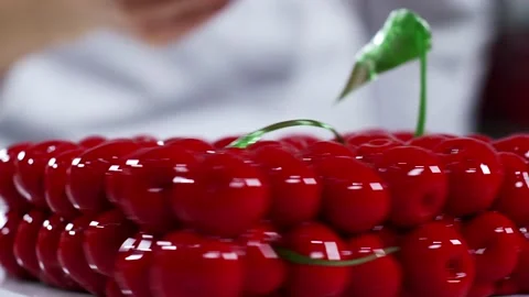 Woman using small spoon to cut pieces from modern 3d cake, close shot of plate Stock Footage 148516448