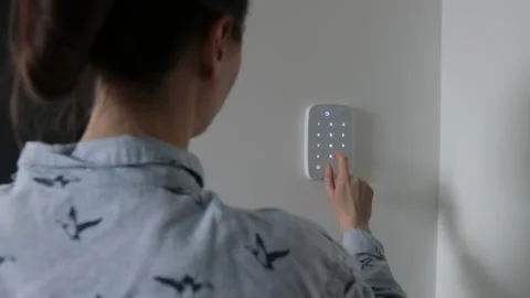 Woman using smart home security system Stock Footage 147870382