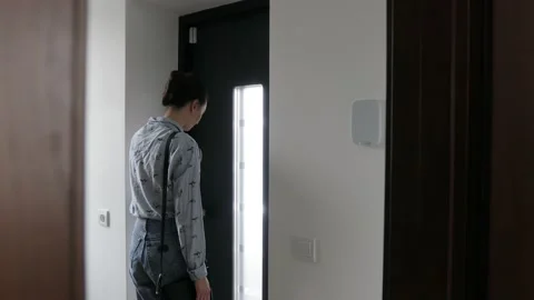 Woman using smart home security system Stock Footage 147870424
