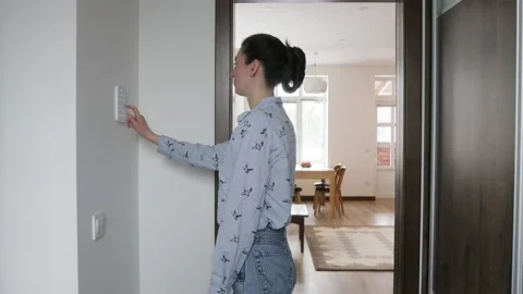 Woman using smart home security system Stock Footage 147870470