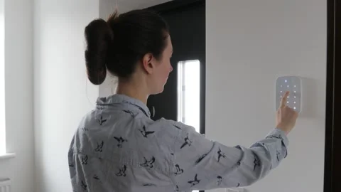 Woman using smart home security system Stock Footage 147870654