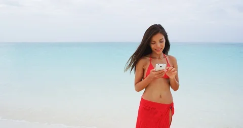 Woman using smart phone app on beach Stock Footage 103451945