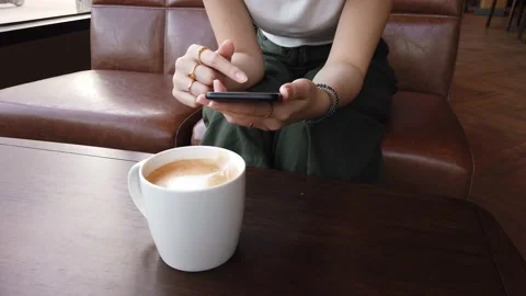Woman using smart phone in coffee shop. Stock Footage