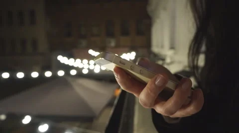 Woman using smart phone mobile in the city at night - Close Up Stock-Footage 64863045