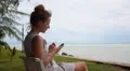 Woman Using Smart Phone at the Sea. HD Footage