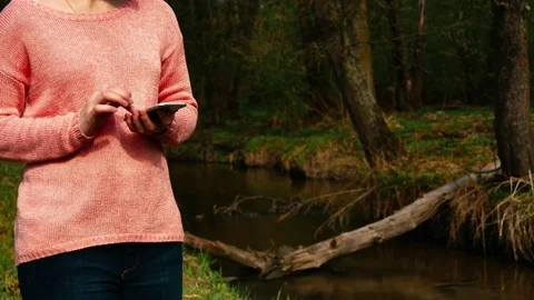 Woman Using Smart Phone In Spring Forest Stock Footage 75247112