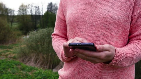 Woman Using Smart Phone In Spring Forest 스톡 동영상 75247179