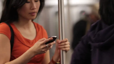 Woman Using Smart Phone in Subway - Standing Stock Footage