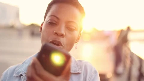 Woman using smart phone at sunset Stock Footage 161726341