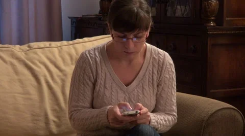 Woman using a smart phone, text messaging, typing Stock Footage 33796974