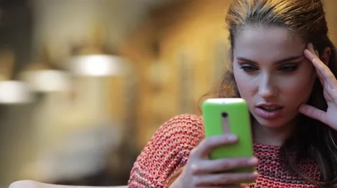 Woman using smart phone touchscreen in cafe drinking coffee Stock Footage 68995301