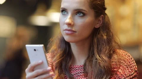 Woman using smart phone touchscreen in cafe drinking coffee Stock Footage 68995305