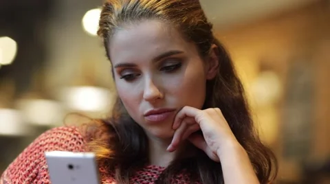 Woman using smart phone touchscreen in cafe drinking coffee Stock Footage 68995314
