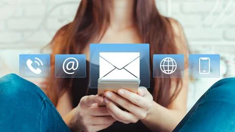 Woman using smartphone to access messaging apps and information in a living Stock Photos