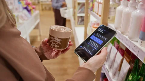 Woman Using Smartphone Ai Assistant App to Check Skincare Product Stock Footage 345514848