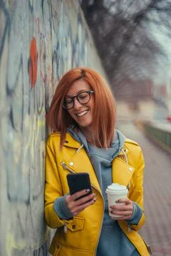 Woman using smartphone and coffee takeaway Stock Photos