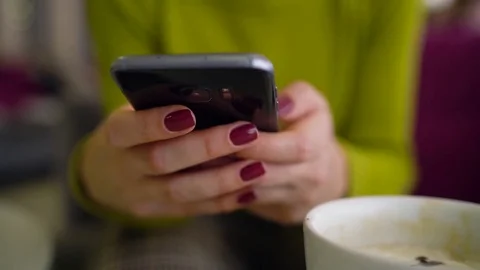 Woman using smartphone and drinking coffee in cafe close up Stock Footage 84797017