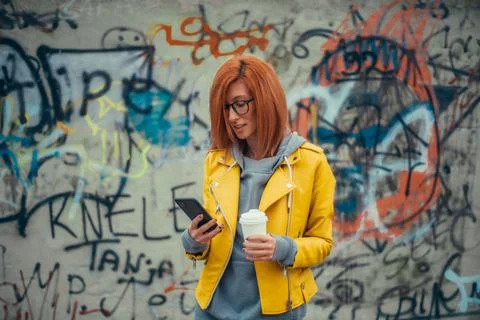 Woman using smartphone and drinking coffee Stock Photos