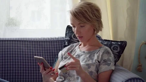 Woman using smartphone and makes online payment by credit card Stock Footage 81531333