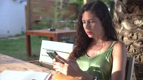 Woman using smartphone and scrolling through social media on mobile phone Stock Footage 345046584