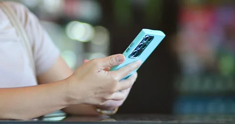 Woman using a smartphone and tapping the screen, mobile technology Stock Footage 338186619