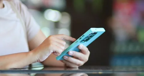 Woman using a smartphone and tapping the screen, mobile technology, communi.. Stock Footage 339303494