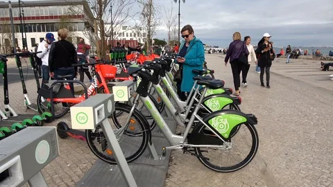 Woman Using Smartphone App To Unlock And Rent A Bicycle In Lisbon Stock Footage 106945392