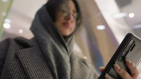 Woman Using Smartphone in Ascending Elevator Stock Footage 310148370