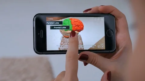 Woman using smartphone with augmented reality app and exploring virtual model Stock Footage 83512540