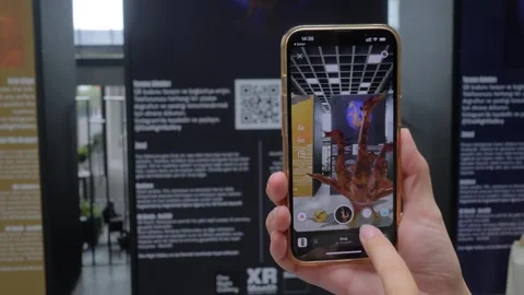 Woman using smartphone with augmented reality app - 3d model of monster Stock Footage 339777402