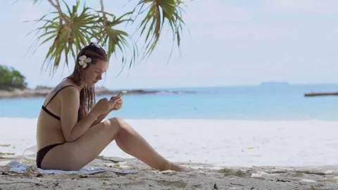 Woman using smartphone at beach drinking. Close up of woman holding. Stock Footage 80562432