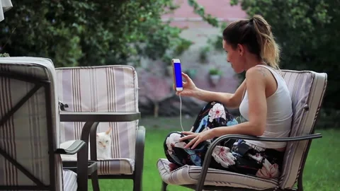 Woman using a Smartphone with Blue Screen during the COVID-19 Pandemic. Stock Footage 127664143