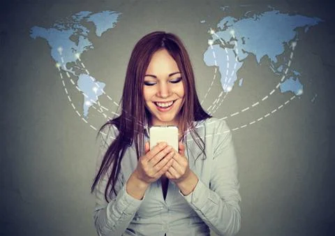 Woman using smartphone browsing internet on worldwide map background Stock Photos