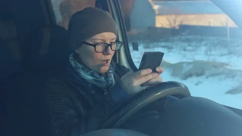 Woman using smartphone in car Stock Footage 71689417