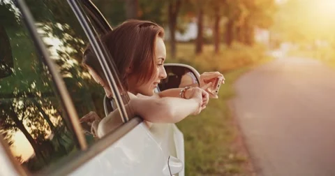 Woman using smartphone in the car. Reading road map and navigation directions Video stock 50958628