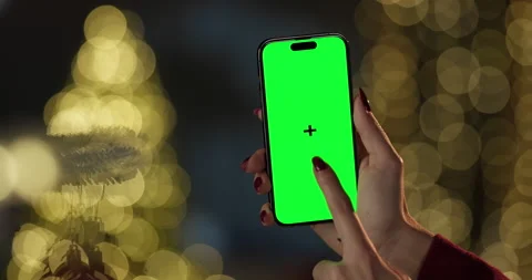 Woman using smartphone with chroma key green screen at night Stock Footage 295661061