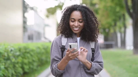 Woman using smartphone in a city Stock Footage 163035976