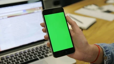 Woman using smartphone with green screen. Close-up video of woman's hands Stock Footage 72361403